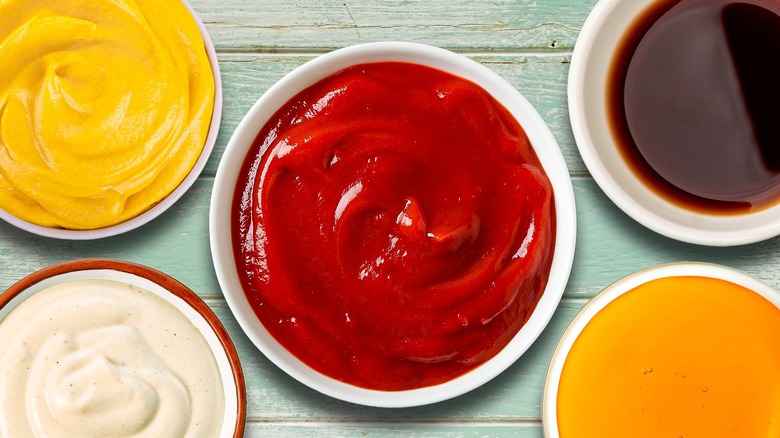 Ketchup and other condiments in small bowls
