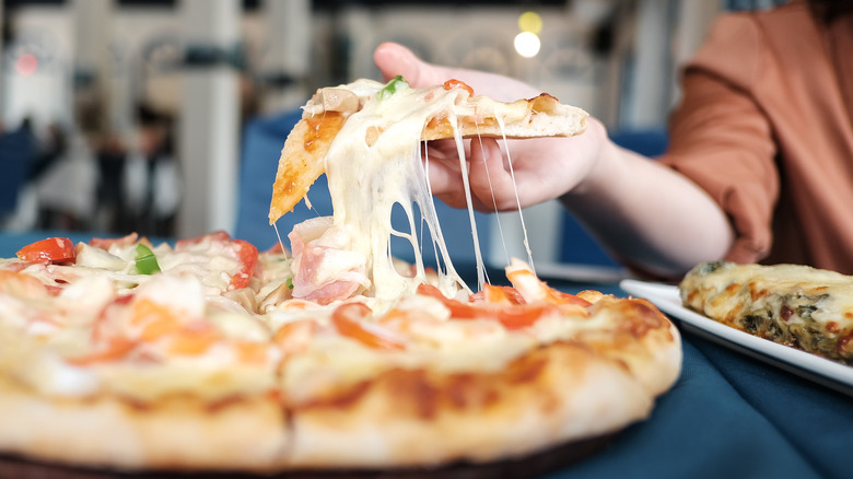 Pizza slice being pulled