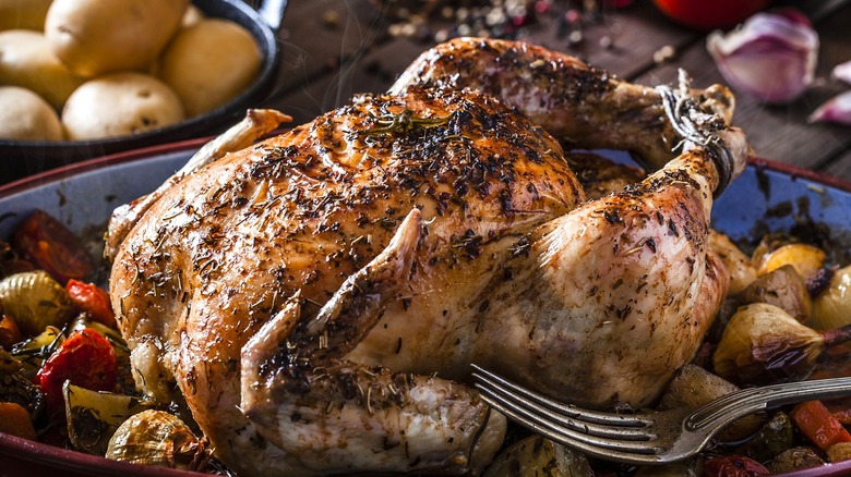 Delicious baked whole chicken with vegetables