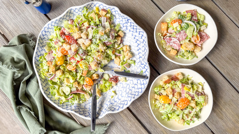 Italian deli grinder salad in serving bowl and plates