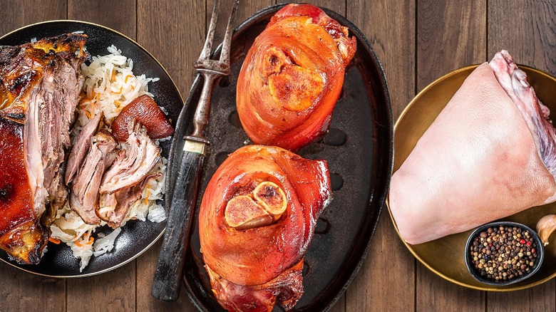 Cooked and cured ham hocks on plates