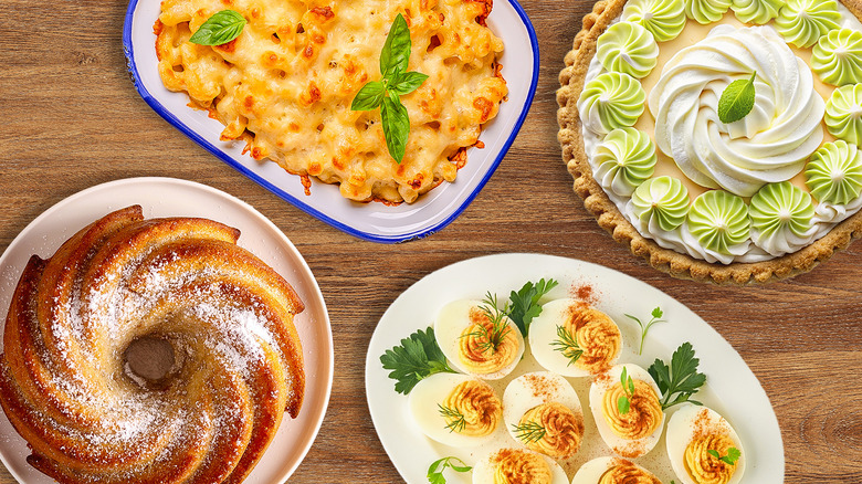 Mac and cheese, Bundt cake, deviled eggs, and key lime pie on wooden table