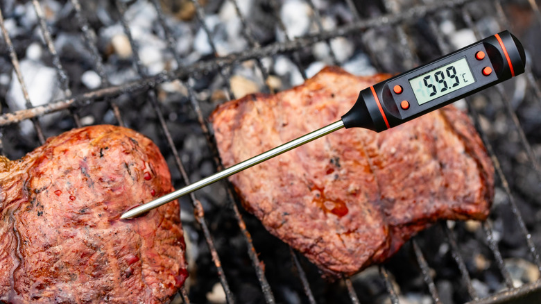 Steak on grill with digital thermometer sticking out