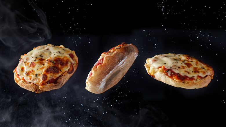 Three small pizzas floating through space with stars behind them