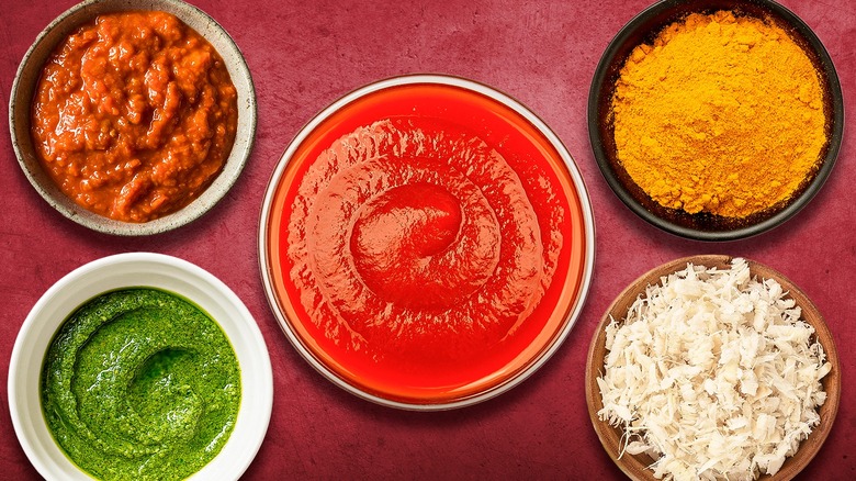 bowl of ketchup with assorted ingredients in bowls