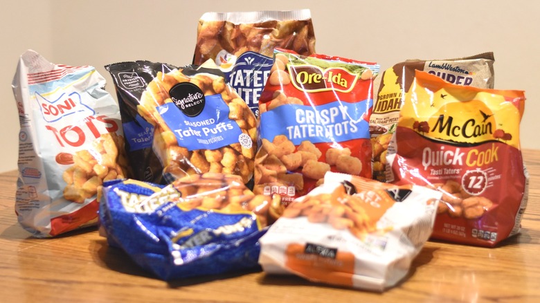 Bags of tater tots on a wooden table