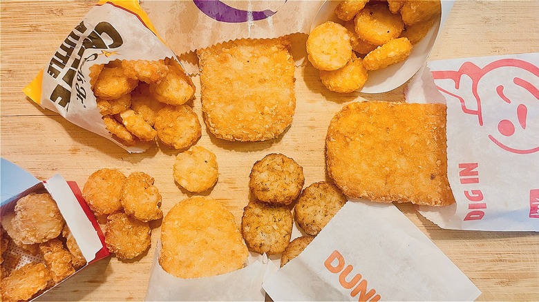 Collection of fast food hash browns on cutting board