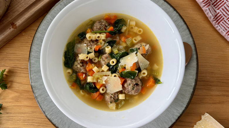 vegetable, meatball, and pasta soup in white bowl