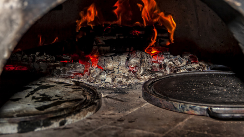 pizza stone in front of pizza oven