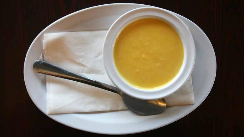 Hollandaise sauce in bowl on tray