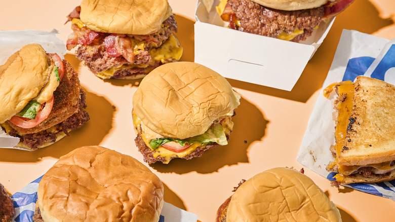 Hamburgers in wrappers on a table