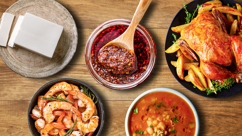 A dish of chili crisp with four dishes on a wooden table