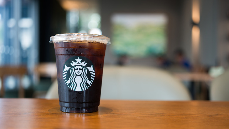 Starbucks iced coffee in a to-go cup on a counter
