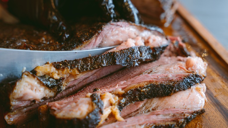 smoked brisket sliced on wood board