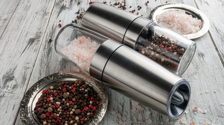 Electric salt and pepper grinders lying on table
