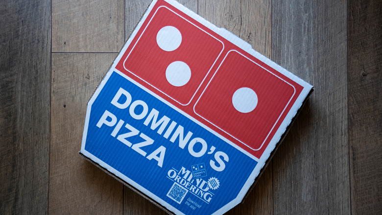 Domino's Pizza box on a wooden background