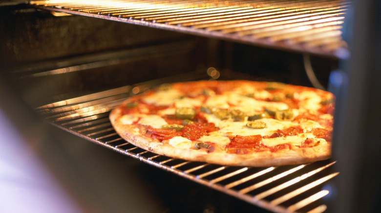Homemade pizza baking in oven