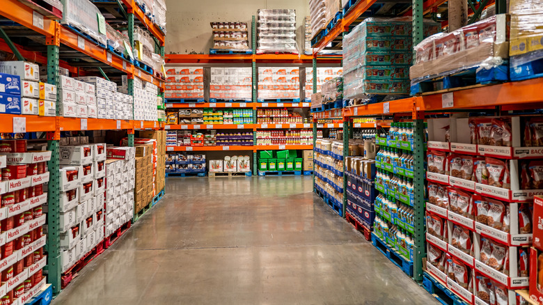 Aisle inside Costco with items like salad dressing and tomato sauce