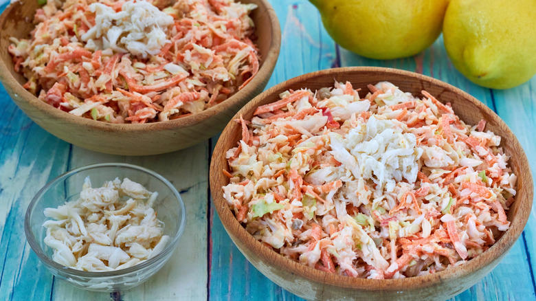 Crab coleslaw in bowls with lemons