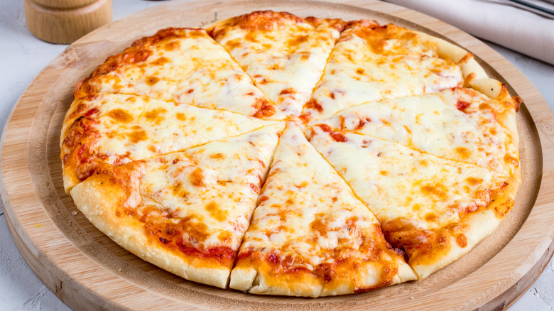 Cheese pizza on wooden board