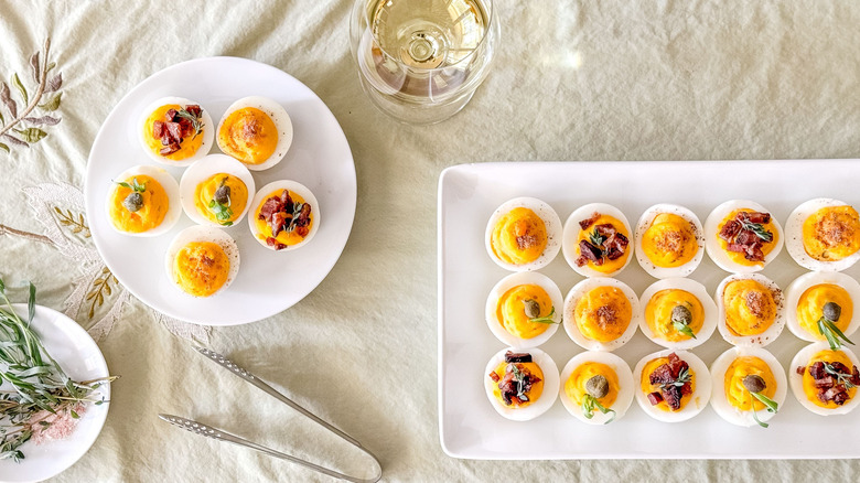 Deviled eggs on platter and plate