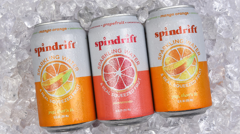Three cans of Spindrift in ice