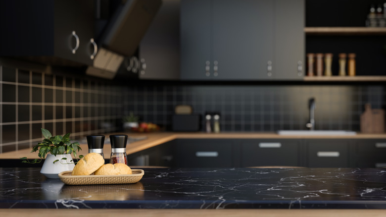 Kitchen with dark wall and cabinets