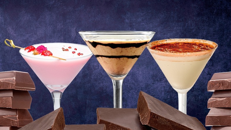 Three martini glasses with different cocktaiils and chocolate bars in the foreground