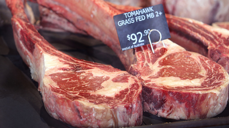 grass-fed tomahawk steaks at a butcher shop