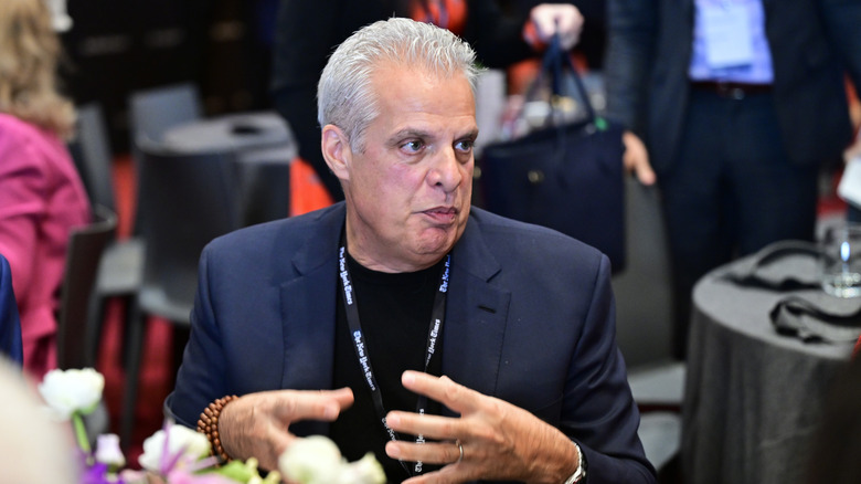 Eric Ripert, mid-conversation at a dining table.