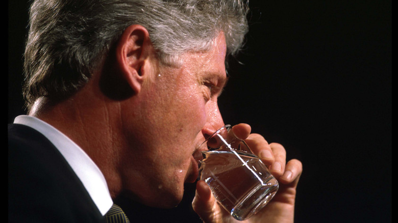 A close-up of former president Bill Clinton drinking