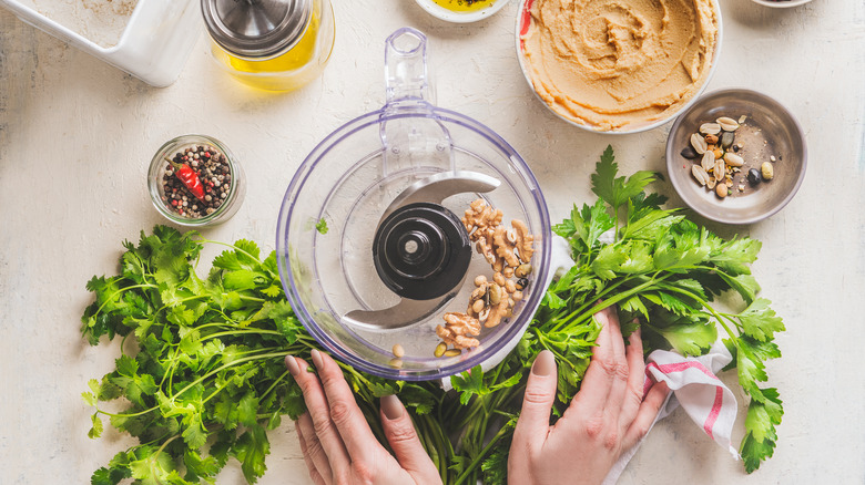 A food processor with ingredients for hummus