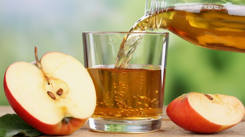 Pouring apple juice in glass