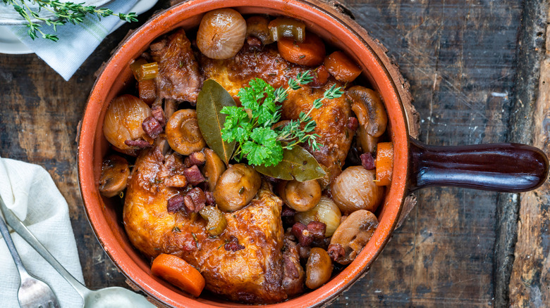 A casserole dish of coq au vin seen from above.