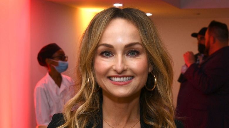 Giada De Laurentiis smiles for camera while holding plates