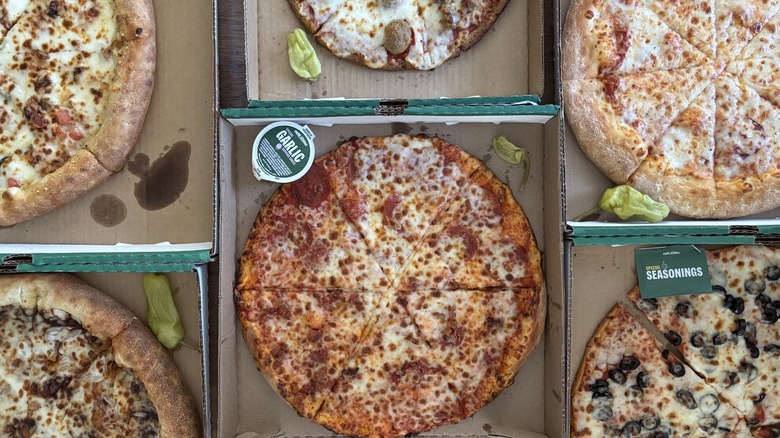 array of pizzas in boxes