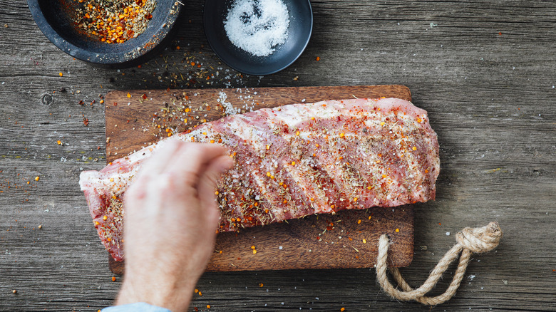 Person seasoning beef short ribs