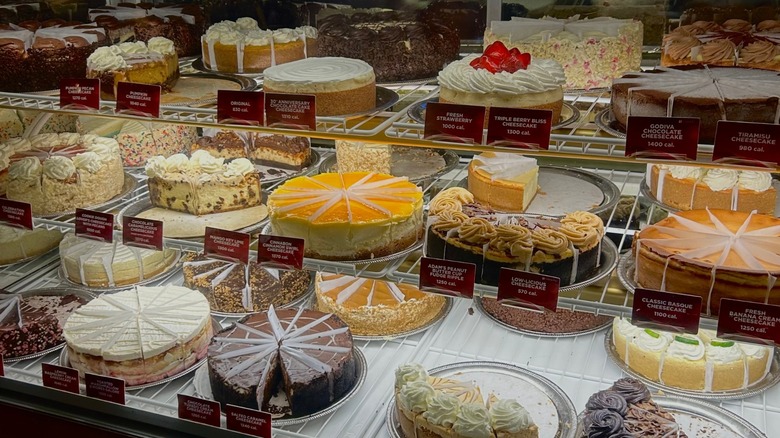 Many different cheesecakes at a Cheesecake Factory.