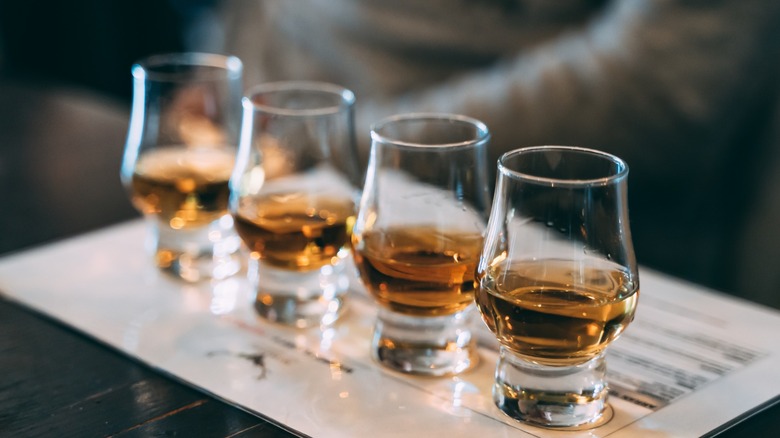 Four Glencairn glasses with whiskey