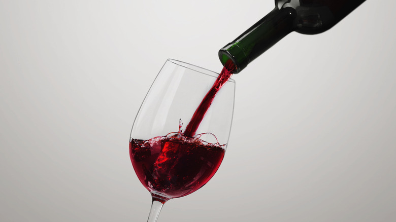 Red wine pouring into glass