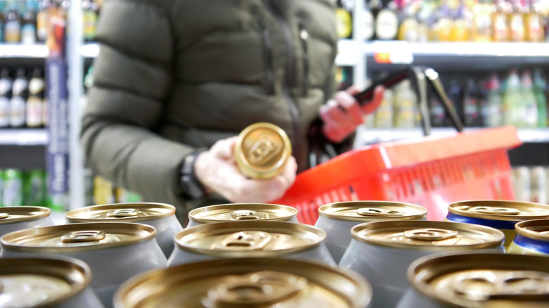 Person buying beer at grocery store