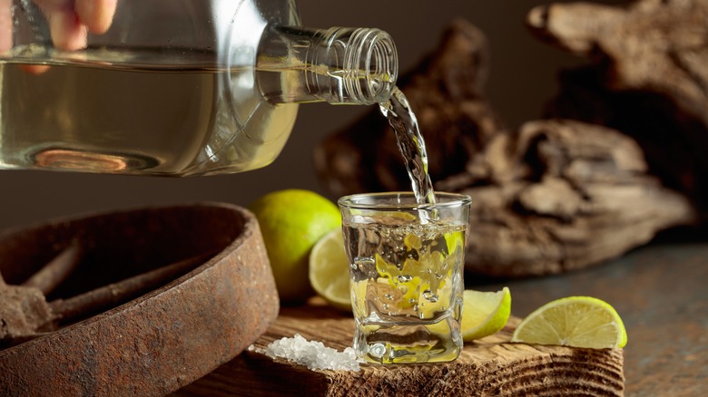 poring tequila into shot glasses