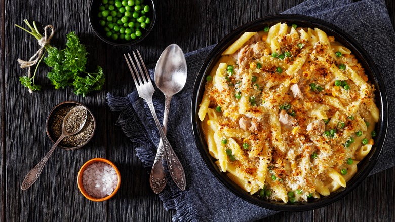 Pasta bake on table with cutlery and seasonings