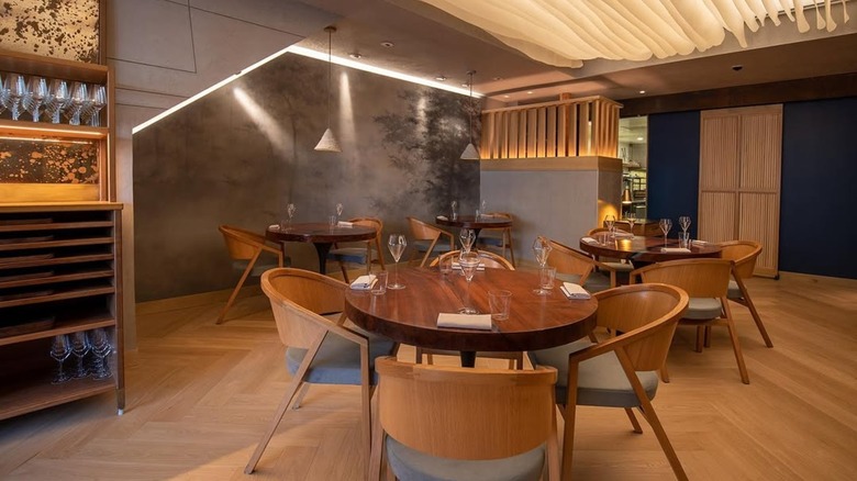 Interior shot of Atelier Crenn's dining tables, wine station, and modern and natural decor style