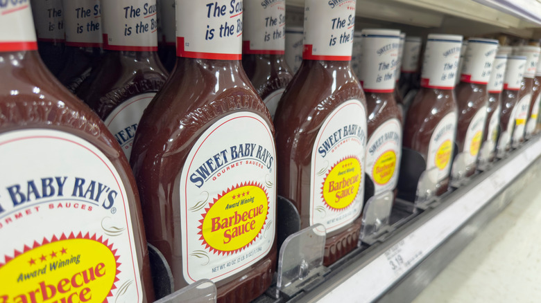 Bottles of Sweet Baby Ray's barbecue sauce on a grocery store shelf