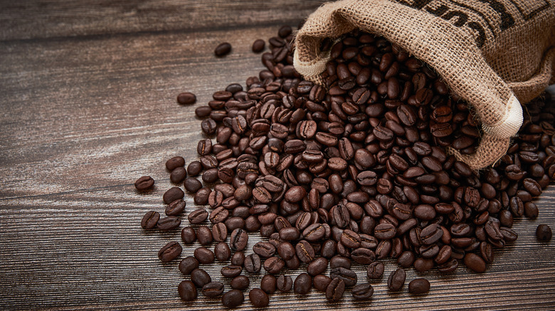 Coffee beans spilling out of a burlap sack