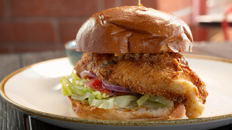 Close-up of a fried catfish sandwich on plate