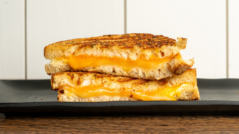 Close-up of stacked and halved grilled cheese on plate