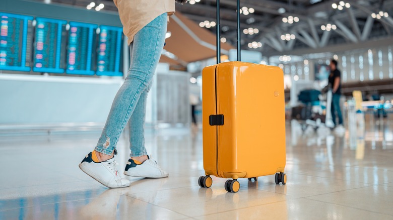 Person with luggage at airport