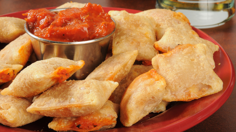 Plate of pizza rolls with tomato sauce